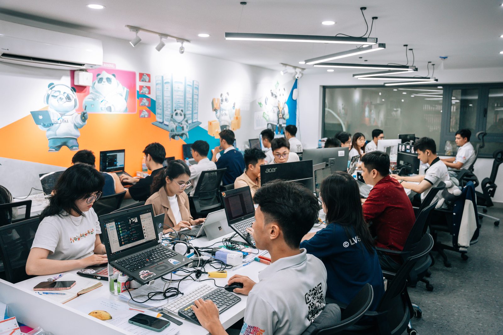 Sàn văn phòng The MONA Group, đội ngũ làm việc chung một chỗ, tường vẽ gấu trúc